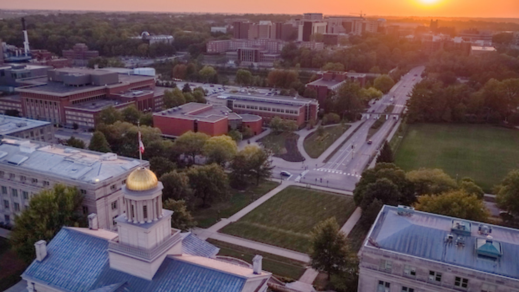 An aerial photograph of the Pentacrest at the University of Iowa at dusk, looking west.