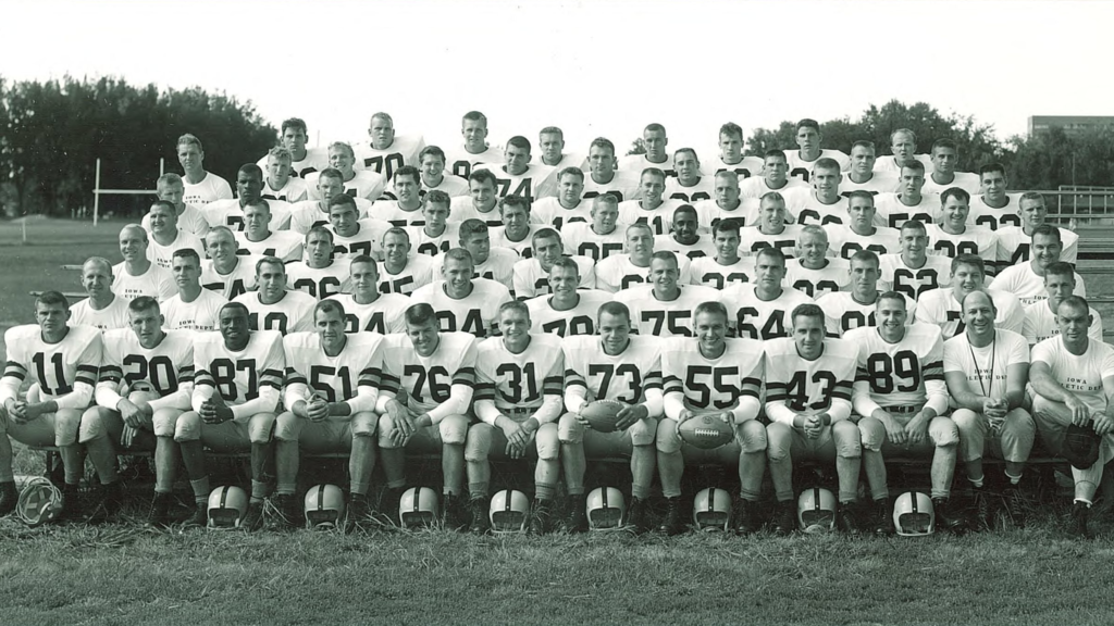 A group photo of the 1956 Iowa football team and coaches