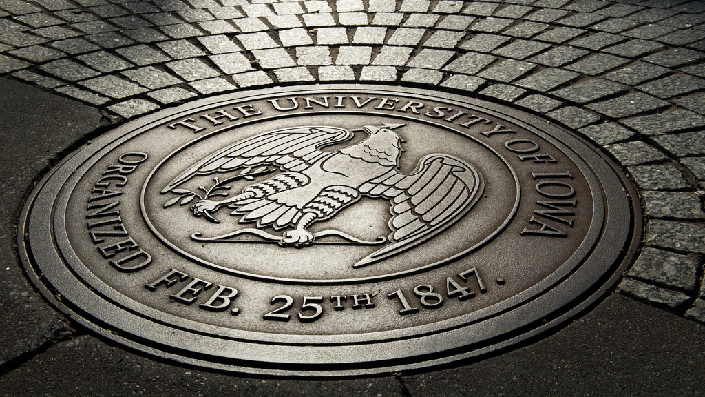 Presidential seal of the university of iowa emblazoned on brick walkway