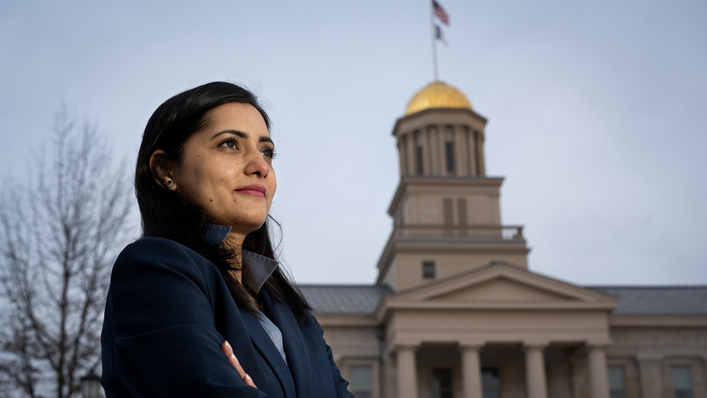 A woman (Gul Rukh Mehboob ) standing outdoors with the University of Iowa Old Capital building in the background